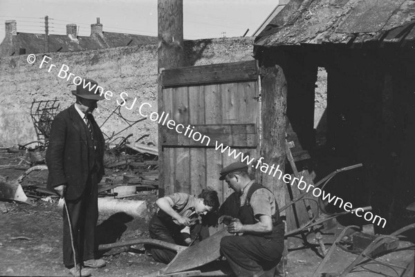 MEN REPAIRING PLOUGH